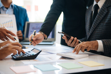 Business team collaboration discussing working analyzing with financial data and marketing growth report graph in team, presentation and digital tablet, laptop.