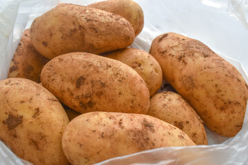 Raw potatoes in a plastic bag
