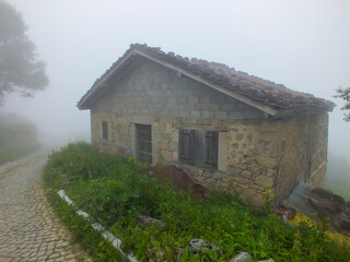  Old stone cottage house in Dumanli Village in foggy weather, Gumushane, Turkiye.