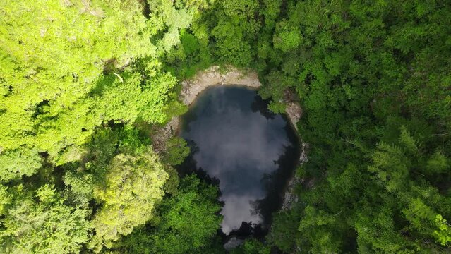Drone aerial top down above emerald pool at lom poo kiew in Lampang Province, Thailand.
