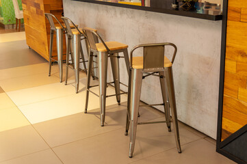 Empty high chairs at the bar counter in a cafe or bar