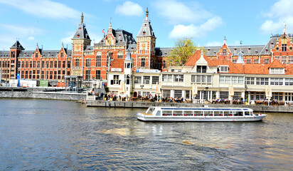 Naklejka premium view of the old city, beautiful canal in the Amsterdam city with ferry in harbor, Amsterdam, north Holland , Netherlands,