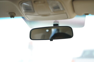 view of a car front mirror at morning on a sedan car.