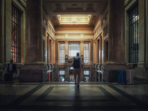 Traveler descending the stairs of a train station 