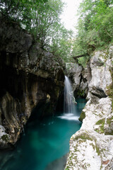 Beautiful waterfall in the big gorge rock cliffs of emerald soca river