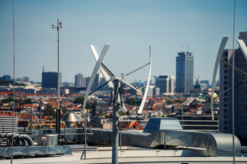 Vertical-axis wind turbine generating renewable energy on a rooftop in Berlin, Germany