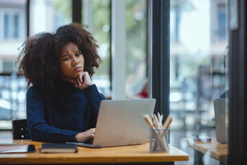 African American are stressed and tired from work sitting at desk in the office, feeling sick at work, stress from work.	