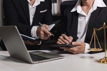 Male lawyer working with contract at desk, justice and law concept.
