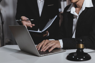 Male lawyer working with contract at desk, justice and law concept.