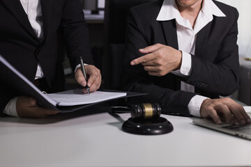 Male lawyer working with contract at desk, justice and law concept.