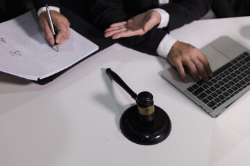 Male lawyer working with contract at desk, justice and law concept.