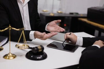 Male lawyer working with contract at desk, justice and law concept.