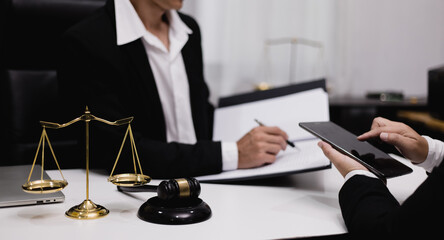 Male lawyer working with contract at desk, justice and law concept.