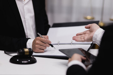 Male lawyer working with contract at desk, justice and law concept.