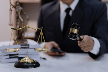 Asian lawyer working with contract at desk, justice and law concept.