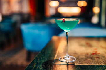 alcohol cocktail in a glass stands on a table in a bar or restaurant