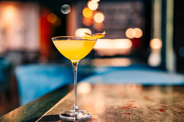 alcohol cocktail in a glass stands on a table in a bar or restaurant