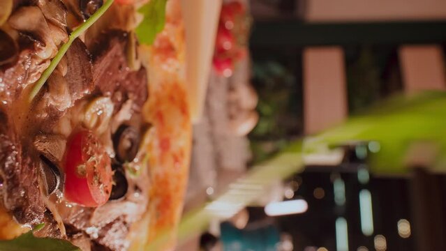 Extra close up shot of meat pizza being served with aragula