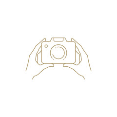 Human hands holding retro photo camera lens minimalist golden line art icon vector illustration