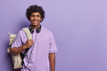 Professsional studio close up of young smiling happy hindu man isolated on purple background...