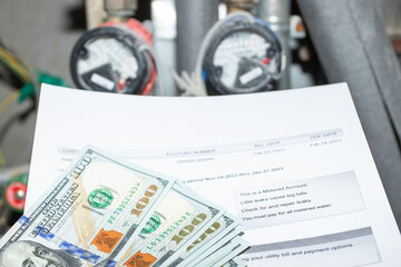 utility receipt and water meters and money dollars cash, Paper bill with energy and water charges