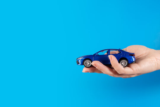 credit for car, auto credit, buy with bank finance, car in hand on a blue background, copy space