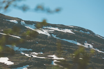 Midnight sun over mountains in remote harsh arctic landscape in Swedish Lapland. 