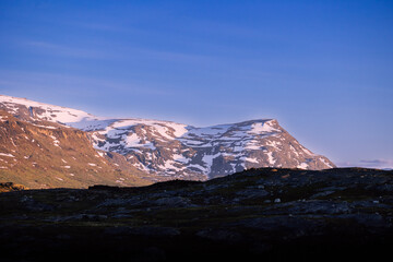 Midnight sun over mountains in remote harsh arctic landscape in Swedish Lapland. 