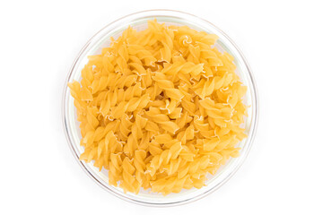 Uncooked Fusilli Pasta in Glass Jar Isolated on White Background. Fat and Unhealthy Food. Classic Dry Spiral Macaroni. Italian Culture and Cuisine. Raw Pasta