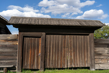 Naklejka premium Large old wooden gate with a fence