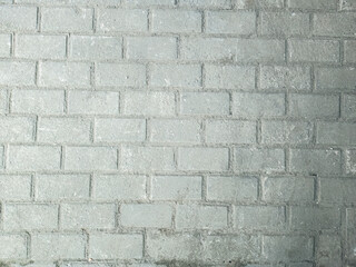 Obraz premium Textured gray brick wall background. Concrete wall for modern design use. Solid stone wall texture for projects. Industrial brick wall for architectural themes. Weathered brick wall close-up shot