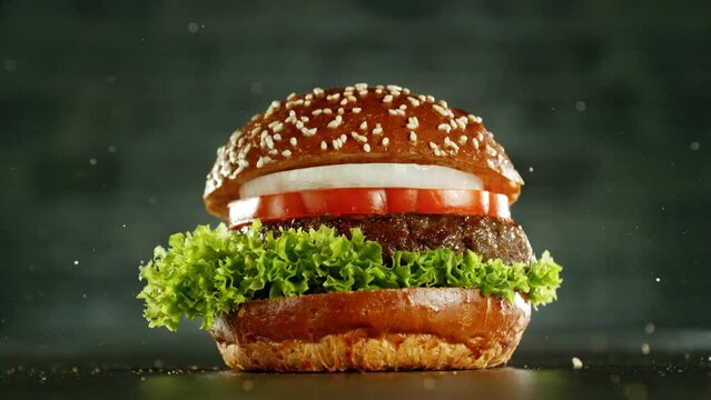 Super slow motion of stacking hamburger pieces. Camera in motion. Filmed on high speed cinema camera, 1000 fps. Placed on high speed cine bot. 