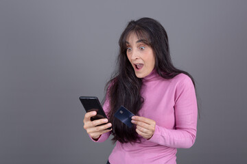 Naklejka premium woman with turtleneck, buying with card and mobile