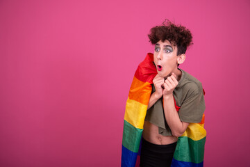 Make up. Funny drag queen posing in the studio on a pink background.