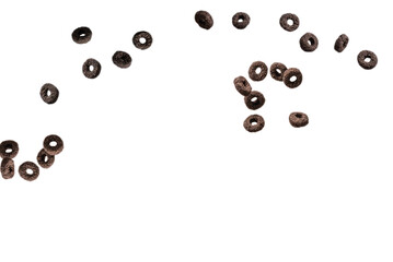 Chocolate rings cereal spill out into a bowl. Breakfast.