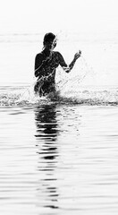 silhouette of a person splashing water
