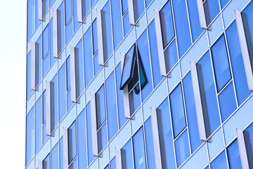 One open window in modern glass wall office building. 