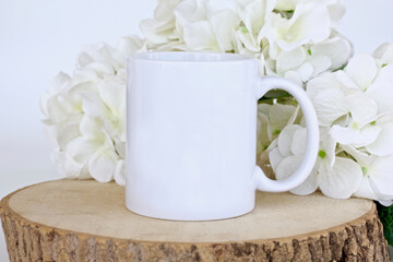 White 11 oz coffee mug mockup with white flowers
