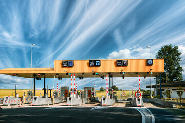 Cars Passing Through The Automatic Point Of Payment On A Toll Road. Point Of Toll Highway, Toll Station. Highway Toll Plaza Or Turnpike Or Charging Point, Entrance On Motorway.