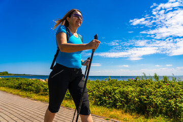 Nordic walking - young woman training 
