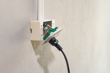Dangerous broken electrical socket falling out of wall. - 624051052
