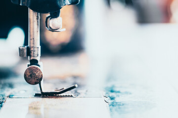 Vintage Stitching: Close-up of an Old Sewing Machine and Clothing - A Technology Idea Background.