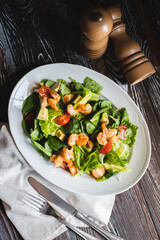 Appetizing salad with shrimps, lettuce, tomatoes and avocado. Food photography.