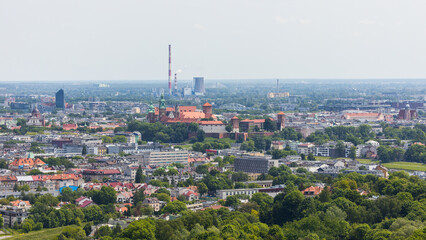 View over the historic city centre of Krakow with industrial plants and smokestacks in the...