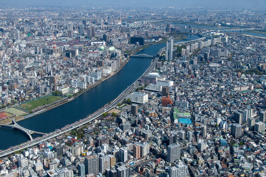 Aerial view of Sumida City and Taito City wards along the Sumida River in Tokyo Japan with a view over the residential and business areas