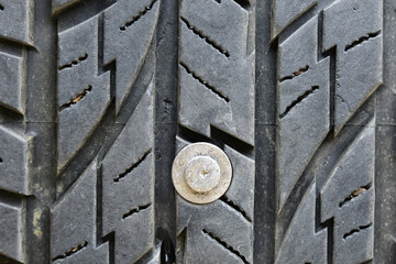 old nail puncturing and jammed in tire close up