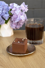 Chocolate mousse cake on a wooden cafe table