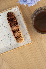 Cake with shortcrust pastry and cream on a wooden cafe table top view, flat lay