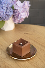 Chocolate mousse cake on a wooden cafe table