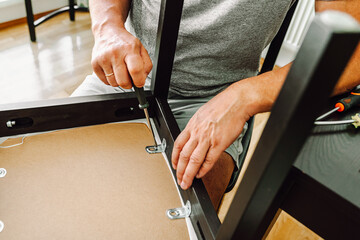 Middle aged man handyman fixing chair at home